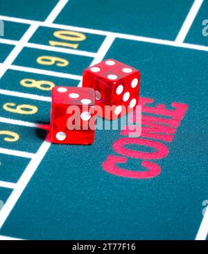 Two red dice on green gambling game gamble concept Stock Photo