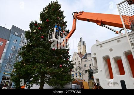 Jena, Germany. 14th Nov, 2023. The Christmas tree on Jena's market square is decorated. The 18-metre-high blue spruce is the focal point of the Jena Christmas market, which takes place from 24 November to 22 December. Credit: Martin Schutt/dpa/Alamy Live News Stock Photo