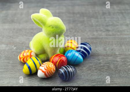 green Easter bunny and Easter eggs on grey underground Stock Photo