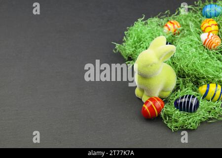 green Easter bunny and Easter eggs on grey underground Stock Photo