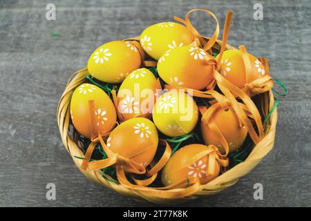 Easter nest with yellow Easter eggs on gray Stock Photo