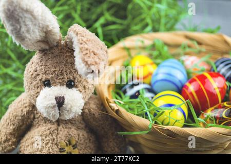 Easter bunny with Easter eggs in Easter nest Stock Photo