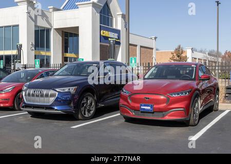 Indianapolis - November 12, 2023: CarMax Auto Dealership Ford Mustang Mach-E and Audi e-tron EV display. CarMax is the largest used car retailer in th Stock Photo