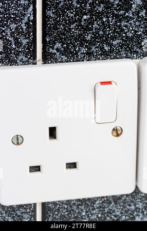 Close up of a toggle switch on a UK plug socket Stock Photo