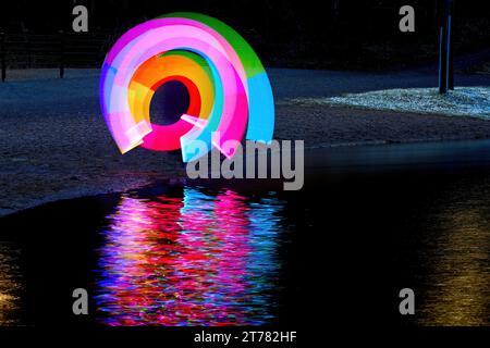 Light painting with multicolored led light stick in darkness Stock Photo