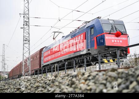 (231114) -- YONGCHUAN, Nov. 14, 2023 (Xinhua) -- This photo taken on Nov. 14, 2023 shows a JSQ freight train preparing to depart at Langantan Station in Yongchuan District of southwest China's Chongqing. The first JSQ freight train from Yongchuan District of southwest China's Chongqing directly to Europe departed on Tuesday. The train is loaded with 232 vehicles manufactured by Great Wall Motors in Yongchuan, with a total value of about 42 million yuan (about 5.76 million U.S. dollars). (Xinhua/Wang Quanchao) Stock Photo