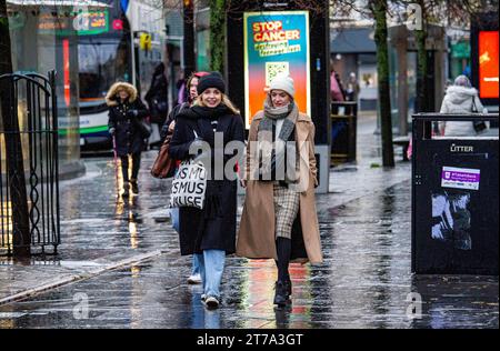 Dundee, Tayside, Scotland, UK. 14th Nov, 2023. UK Weather: Storm Debi arrives in Tayside, bringing cold temperatures and heavy rain showers. Local residents in Dundee spend the day bundled up against the rain and chilly weather while out and about the city centre. Credit: Dundee Photographics/Alamy Live News Stock Photo