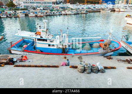 Busan, South Korea - March 16, 2018: Small fishing boat is moored in old fishing harbor of Busan city Stock Photo