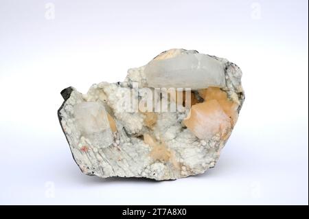 Apophyllite (white) and stilbite (orange). Apophyllite is a phyllosilicate and stilbite is a tectosilicate. This sample comes from India. Stock Photo