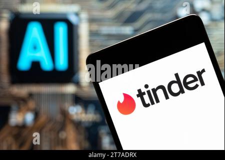 In this photo illustration, the mobile dating app Tinder logo seen displayed on a smartphone with an Artificial intelligence (AI) chip and symbol in the background. Stock Photo