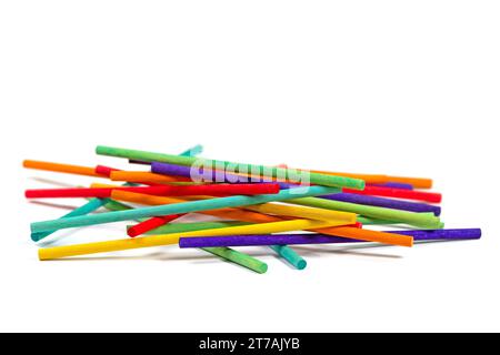 Lots of colorful wooden sticks against a white background Stock Photo