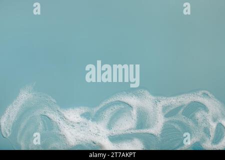 foam soap suds on green background, laundry cleaning washing concept Stock Photo