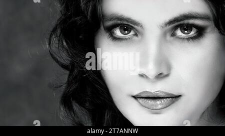 Black and white face close-up portrait of a young dark-haired woman Stock Photo