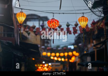 Traditional lanterns hanging on old street in Hoi An in Vietnam. Night life in ancient town. Stock Photo