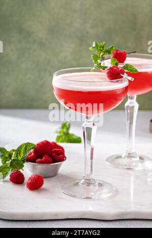 Raspberry martini in coupe glasses, elegant berry drink idea Stock Photo