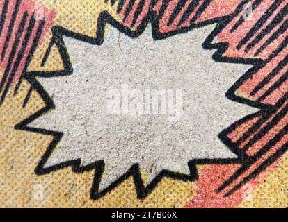 Closeup of real vintage comic book page with empty white speech bubble on a background texture of colorful red and yellow printing dots Stock Photo