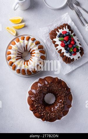 Variety of homemade bundt cakes and loaf cakes ready to eat overhead view Stock Photo