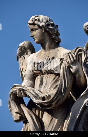 Italy, Rome, angel statue on Sant'Angelo bridge, angel with garment and dice Stock Photo