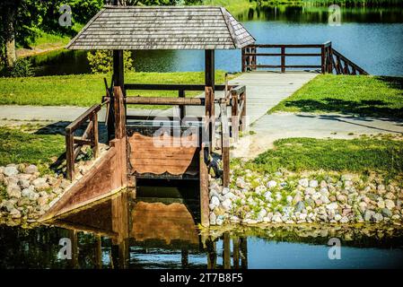 Wooden sluice on the summer river. Stock Photo