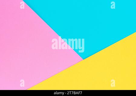 Yellow, pink and purple colored paper. Geometric empty paper background of three tones for copy space. Stock Photo