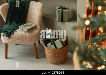 Illuminated Christmas tree and wrapped gifts in a stylish living room decorated for Christmas Stock Photo