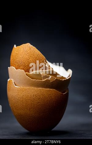 close-up view of brown egg shells stacked on a black background Stock Photo
