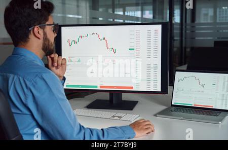 Business man trader crypto investor analyzing stock market using computer. Stock Photo