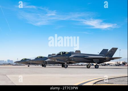 Three F-35 Lightning II aircraft sit on the taxiway at Nellis Air Force Base, Nevada, Nov. 2, 2023. F-35s from the RAAF and various aircraft from the 53rd Wing, conducted interoperability training to evaluate capabilities in a realistic training environment. (U.S. Air Force photo by Airman 1st Class Elizabeth Tan) Stock Photo