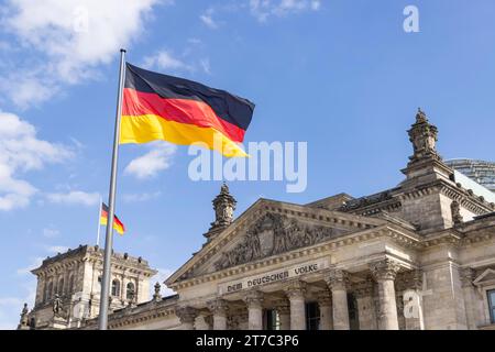 Reichstag building with waving German flag, city view Berlin, Germany Stock Photo