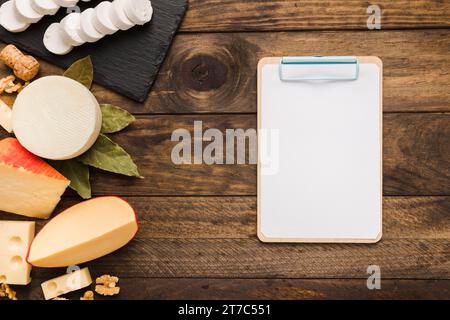 Top view organic various chesses clipboard with empty page Stock Photo