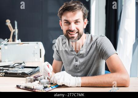 Portrait happy man repairing circuit board computer Stock Photo