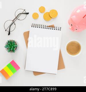 Top view financial elements arrangement with empty notepad Stock Photo