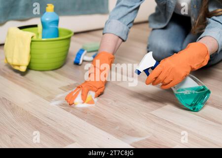 Woman with rubber gloves cleaning floors Stock Photo