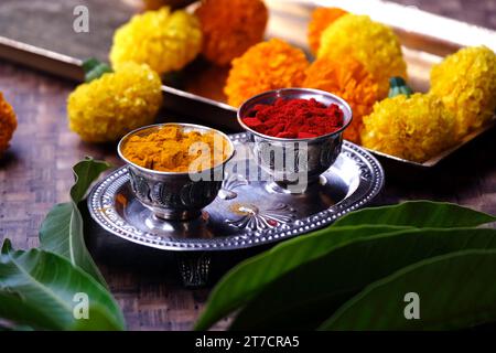 India's tradition Turmeric (Haldi) powder and kumkum powder in silver bowl for pooja. Stock Photo