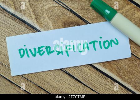 Concept of Diversification write on sticky notes isolated on Wooden Table. Stock Photo