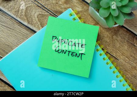 Concept of Duplicate Content write on sticky notes isolated on Wooden Table. Stock Photo