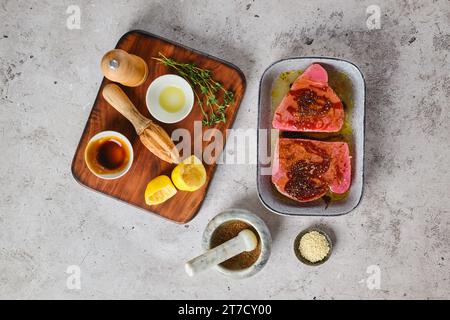 Top view of marinated with spice and herbs ahi tuna steak in a bowl Stock Photo