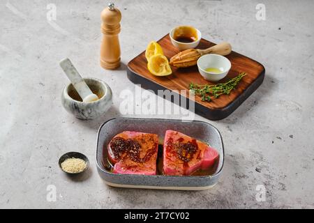 Marinated with spice and lemon juice ahi tuna steak in a bowl Stock Photo