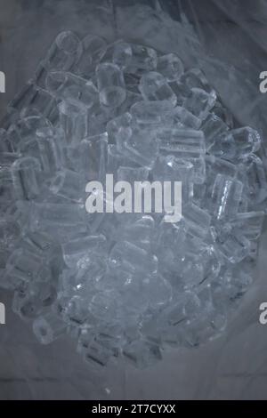 Crystal ice cube pieces in a white plastic bag Stock Photo