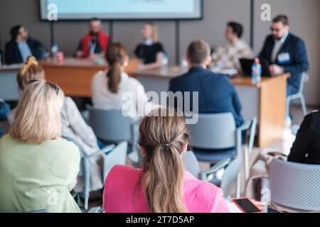 Businesswomen attending conference meeting with colleagues in boardroom at office Stock Photo