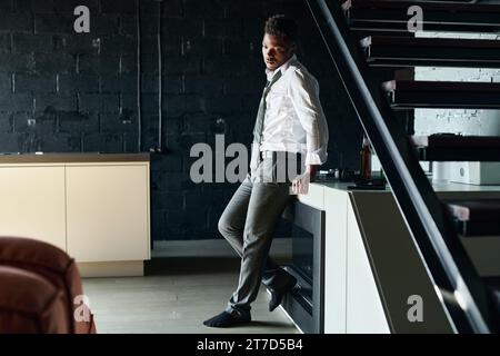 African American young man staying alone with his problems, he suffering from alcohol addiction Stock Photo