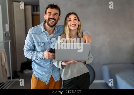 Couple of young designers working at modern home office, two coworkers discussing fun project Stock Photo