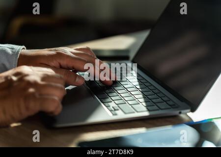 man using a laptop typing, searching, web browsing, online on a computer Search engine optimization SEO technology connection job search Stock Photo