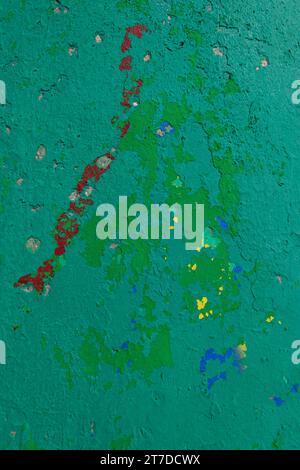 Green, yellow, red, and blue paint covers a weathered, cement beacon marking the entrance to the Tel Aviv marina. Stock Photo
