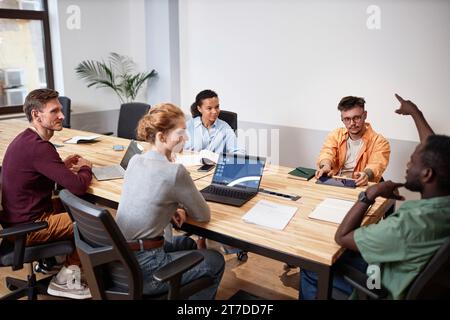 Group of business people using computers while working in team at meeting Stock Photo