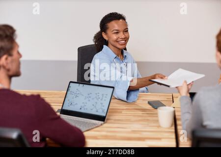 Young businesswoman having meeting with her colleagues at meeting in office Stock Photo