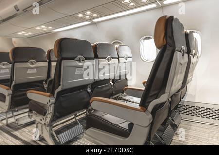 Aircraft passenger seats row chair economy class in cabin air plane Stock Photo