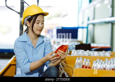 Drink beverage factory QC audit staff quality control final product inspector checking process Stock Photo