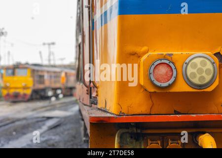 old locomotive diesel train in the rail track close up front headlight Stock Photo