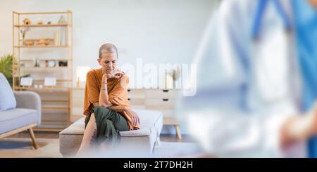 Anxiety and senior woman thinking of mental health problem on the living room sofa in house. Sad elderly person with depression, home stress and Stock Photo